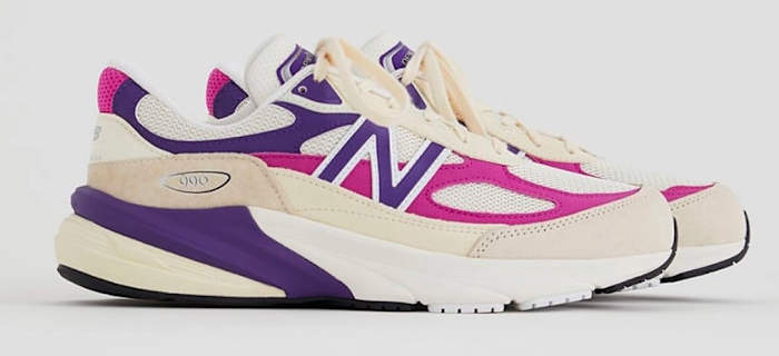 Side view of cream, pink, and purple New Balance shoes.